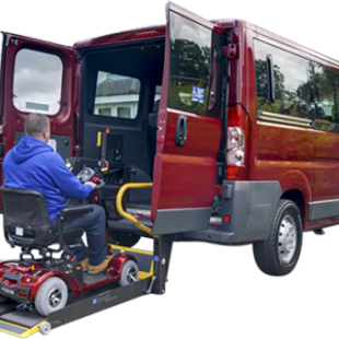 Person on a mobility scooter being helped into a minibus using a tail lift