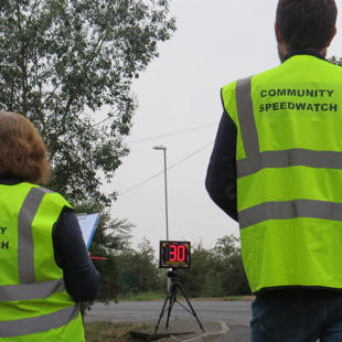Two Community Speedwatch volunteers monitoring speeding