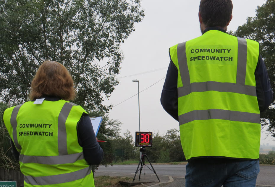 Two Speedwatch volunteer monitoring car speeds