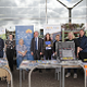 Image of the officers and staff from the Vision Zero Partnership, Road Victims Trust, the In Car Safety Centre, Speedwatch and Police and Crime Commissioner standing behind information stalls in Cambridge City